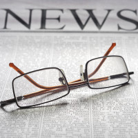 Decorative image of reading glasses on a newspaper that reads "News"